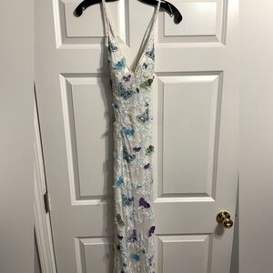 Long, ivory beaded dress from Mimi’s Prom. Size 4, open back with butterflies.